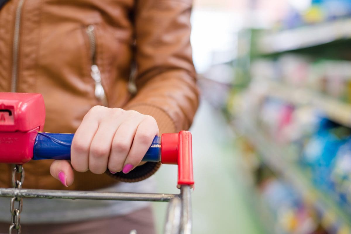 Close Up On Hand Of A Woman On A Supermarket Cart