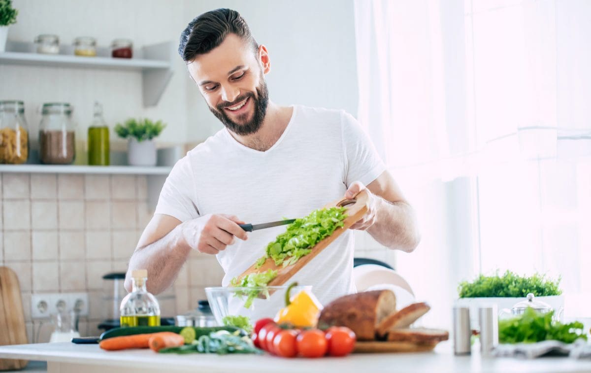 Man making a salad in his home kitchen