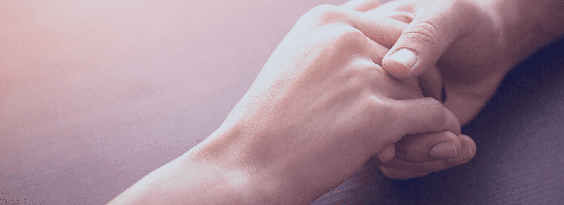 Two hands holding each other