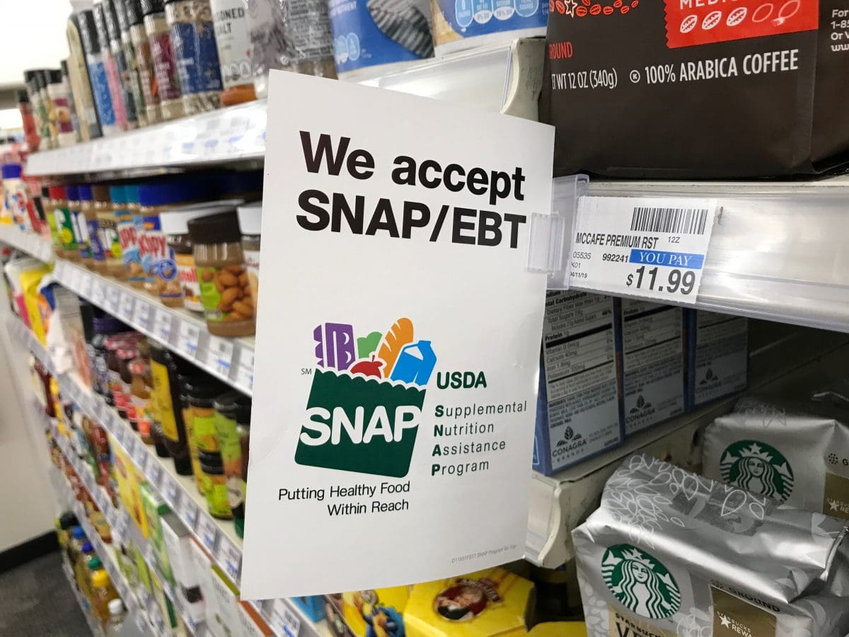 Sign saying "We accept SNAP/EBT" at a grocery store